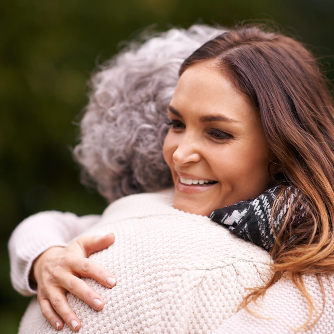 Home Health Care Halstead KS closeup of caretaker giving elderly woman a hug