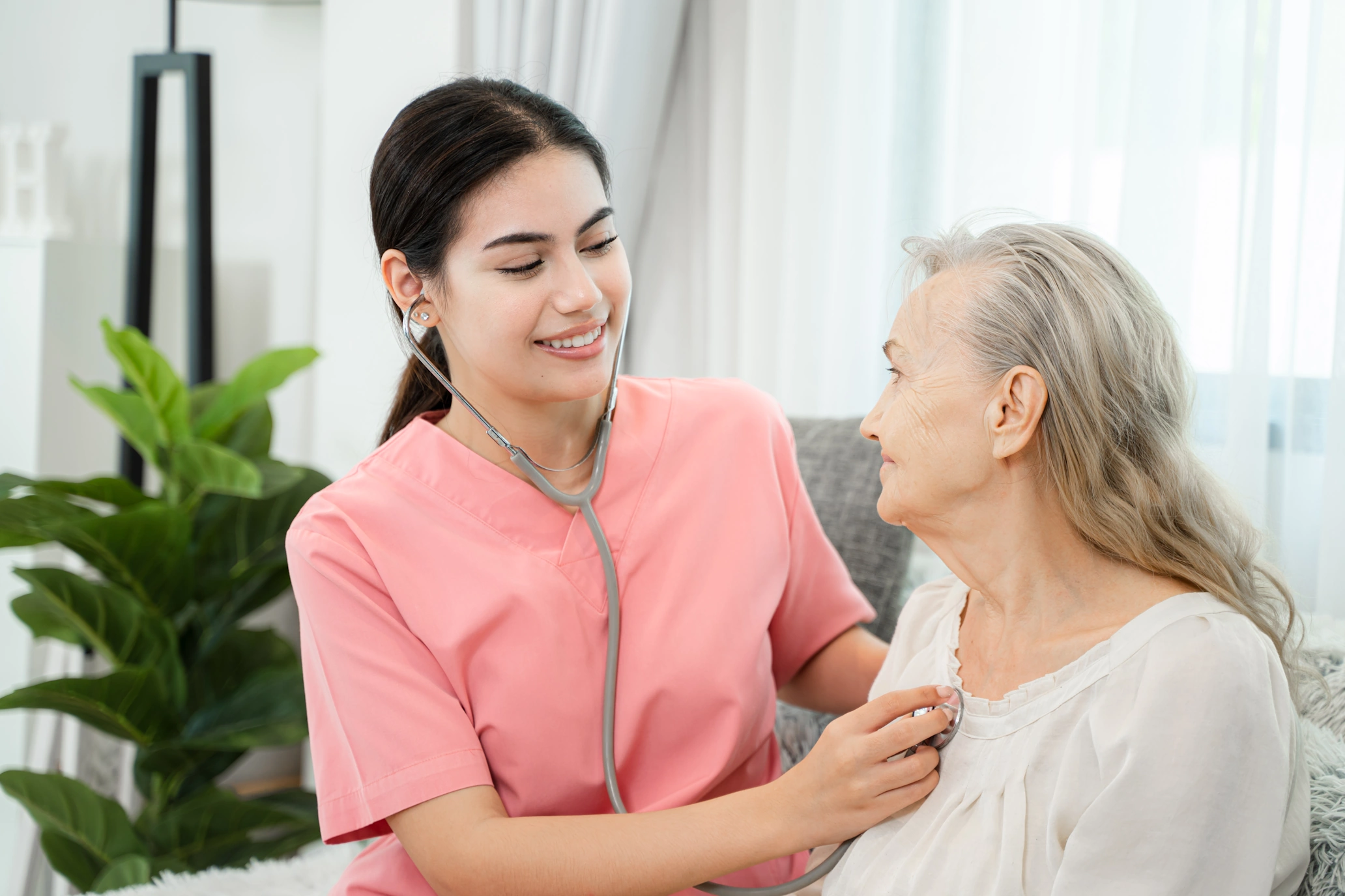 caregiver checks heart rate of senior
